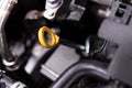 Yellow oil dipstick in car engine Royalty Free Stock Photo