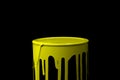 Yellow oil paint flowing down on wall of metal bucket. Isolated Royalty Free Stock Photo