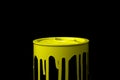 Yellow oil paint flowing down on wall of metal bucket. Isolated Royalty Free Stock Photo