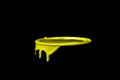 Yellow oil paint flowing over the part of metal bucket Royalty Free Stock Photo