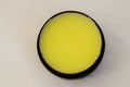 Yellow ointment in a round jar