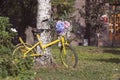 Yellow old bicycle with basket filled with flowers Royalty Free Stock Photo