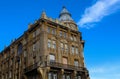 Yellow old building with ruined facade with blue sky in the background Royalty Free Stock Photo