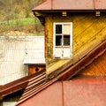 Yellow old fashioned wooden building with white window and with Royalty Free Stock Photo