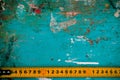 Yellow old ruler on a grunge background smeared with paint Royalty Free Stock Photo