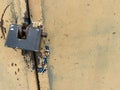 Yellow old scratched padlock metal sheet, iron rusty surface with peeling paint. The background. Texture Royalty Free Stock Photo