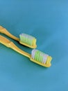 a yellow old toothbrushes on a green background Royalty Free Stock Photo