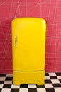 Yellow old vintage retro refrigerator on a pink background Royalty Free Stock Photo