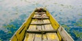 Yellow old wooden boat on calm and quiet lake water Royalty Free Stock Photo