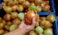 Yellow onions are sweet and astringent in the hands of women in the market street. Pictures from mobile phones