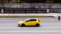Yellow Opel Corsa D Facelift on the city road. Fast moving car on Moscow streets. Vehicle driving along the street in city with