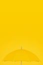 Yellow open umbrella on yellow background, copy space, autumn fall concept, vertical billboard poster