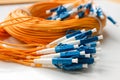 Yellow optical fiber network cable with blue connectors isolated on white background Royalty Free Stock Photo