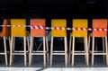 Yellow and orange bar stools in the cafe are rewound with striped prohibitory tape. Royalty Free Stock Photo