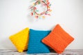 Yellow, orange and blue knitted cushions