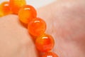 Yellow orange bracelet beads on wrist Royalty Free Stock Photo