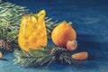 Yellow orange cocktail with tangerine and rosemary in glass on dark blue concrete background decorated pine branches with cones, Royalty Free Stock Photo