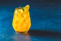 Yellow orange cocktail with tangerine and rosemary with ice in glass on dark blue concrete background , close up. Christmas and Royalty Free Stock Photo