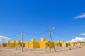 Yellow and orange colored row houses, terraced houses all built in the same style, Chilecito, La Rioja, Argentina Royalty Free Stock Photo