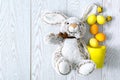 Yellow and orange easter eggs in decor bucket with rabbit toy, spring, easter concept Royalty Free Stock Photo