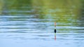 Yellow-orange fishing float on the surface of the water Royalty Free Stock Photo