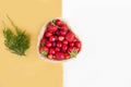 Fresh cherries and red ripe strawberries on a white plate Royalty Free Stock Photo