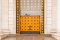 Yellow orange large wooden doors decorated with metal stars. Close-up. Astana Opera and ballet Theatre. Astana Nur-Sultan,