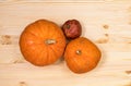 Yellow orange pumpkins and pomegranate on a light wooden table, Halloween concept and autumn pumpkin harvest, farm product Royalty Free Stock Photo