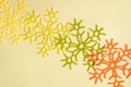 Yellow and orange and red autumn snowflakes knitted on a yellow background. Handmade and creativity. Beautiful background. Autumn