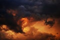 Yellow orange red blue black sky with clouds. Dark dramatic background. Fire, glow. Storm, lightning. Or war, horror concept.