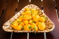 Yellow orange ripe habanero hot chili peppers on a wooden plate Royalty Free Stock Photo