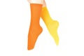 Yellow and orange socks on woman foot isolated on white background