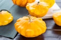 Yellow and orange summer squash, small pumpkins on a wooden table, autumn harvest, thanksgiving and farm food concept