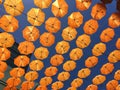 Yellow orange umbrellas hung on the roofs on the street