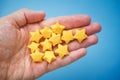 Yellow origami lucky stars in a hand