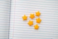 Yellow origami lucky stars on a lined paper