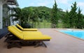 Yellow outdoor recliner chair next to the pool