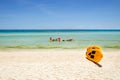 Yellow paddle boards and children boats on tropical beach