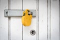 Yellow Padlock on a White Metal Door Security Background