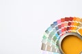 Yellow paint can and color palette on white background, top view. Royalty Free Stock Photo