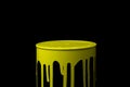 Yellow paint flowing down on wall of metal bucket. Isolated Royalty Free Stock Photo