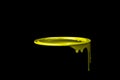 Yellow paint flowing down on wall of metal bucket. Isolated over Royalty Free Stock Photo