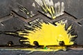 Yellow paint splash from a crashed paintball on an old car tire with a zigzag tread pattern Royalty Free Stock Photo