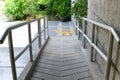 Yellow painted handicapped sign traffic symbol on the floor in front of ramp way for support wheelchair