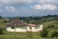 Yellow painted mud hut / rondavel with thatched roof in the Transkei area, Wild Coast, South Africa