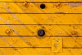 Yellow painted old wooden boards with holes. Natural wood texture. Abstract background Royalty Free Stock Photo