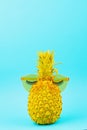 Yellow painted pineapple in sunglasses with artificial lashes. Humour, summer patry concept