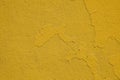 Yellow painted plaster wall. Wall concrete background. Old cement texture, cracked. Wallpaper abstract grunge background Royalty Free Stock Photo