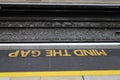 Painted Sign \'Mind The Gap\' on Platform Edge of Railway Station in Close Up Royalty Free Stock Photo