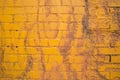 Yellow painting on brick wall